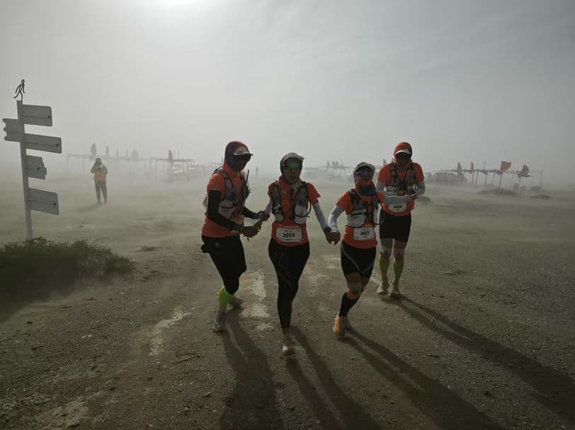 Runners braving a sandstorm in the Gobi Desert
